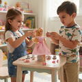 Girl in striped tee denim dungarees brushing Gingham Girls doll golden hair pink comb boy in dinosaur tee holding silver teacup pastel nursery table silver miniature tea set pink macaron tiny pink shoes