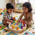 Indian toddler boy striped tee Indian girl beige block-print kurta red bindi cross-legged colourful alphabet play mat both smiling SpiralQuest spiral board blue peg girl pointing centre wooden puzzle foam shapes scattered