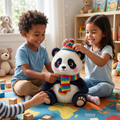 Two children sitting on world map playmat laughing and placing a rainbow pompom hat on Bamboo the panda plush