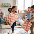 Five children laughing and having an epic pillow fight with coral zigzag chevron cushions in a bright playroom
