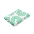 Soft baby blanket in mint green and white with elephant swirl print folded neatly