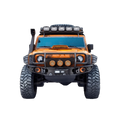 RC Off-Road Monster Crawler front view showing orange body battle damage graphics steel bull bar auxiliary lights and massive mud-terrain tyres