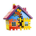 Segway Puzzle House Building Set completed 3D house purple A-frame roof red chimneys yellow pots salmon roof sky-blue gable multi-colour puzzle pieces yellow walls orange red panels white windows